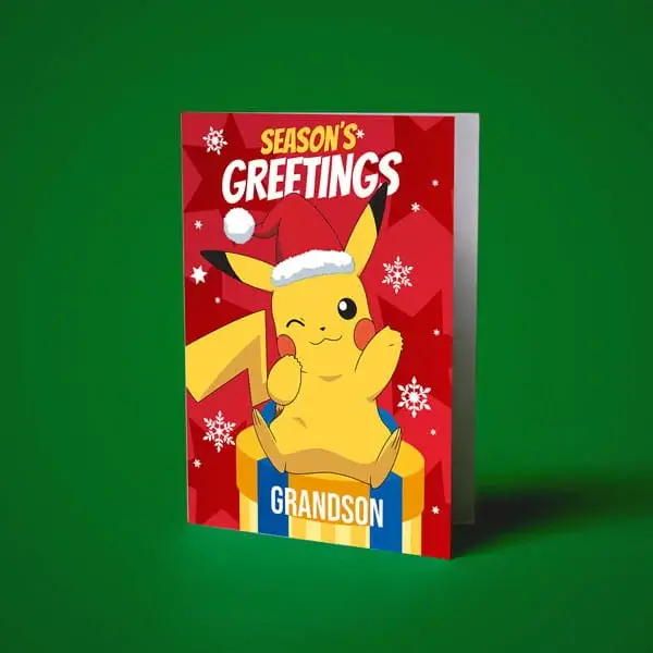 Pokémon Christmas card featuring Pikachu wearing a Santa hat, sitting on a gift box with Seasons Greetings and Grandson text.